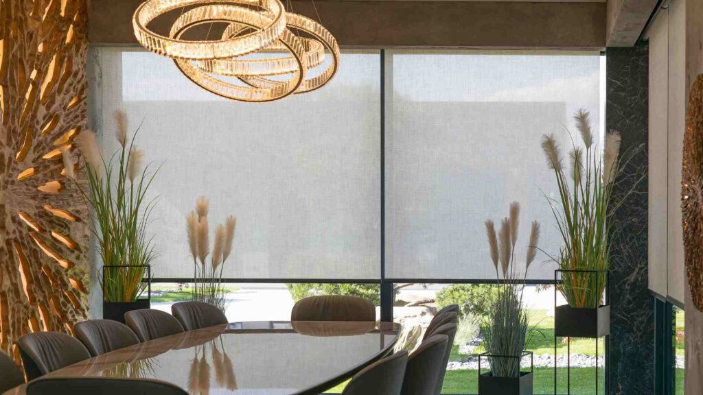 a dining room with a large table and chairs in front of a large window